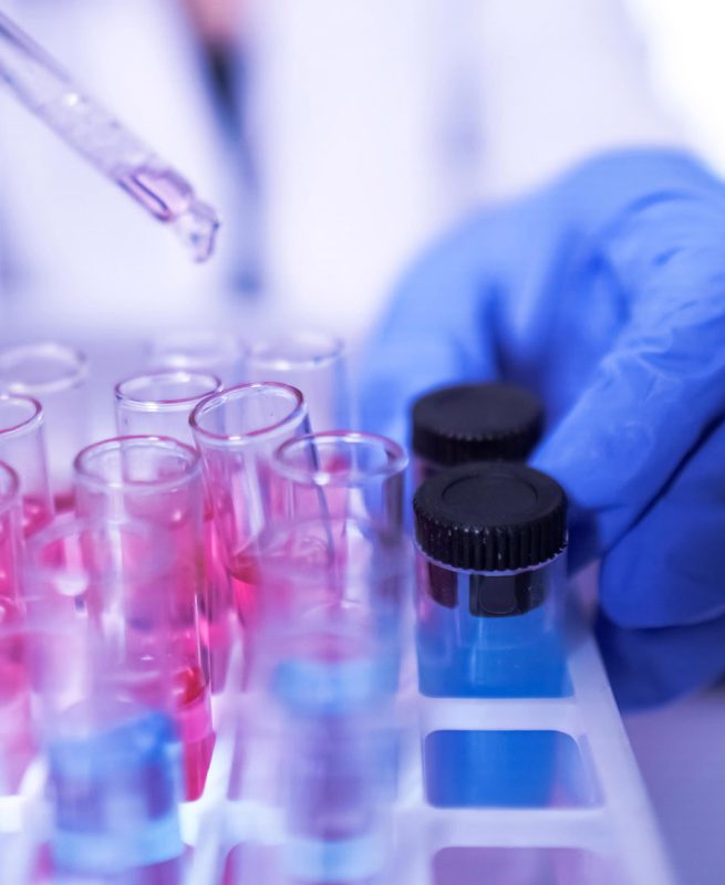 female lab technician doing research with a microscope in the lab. coronavirus